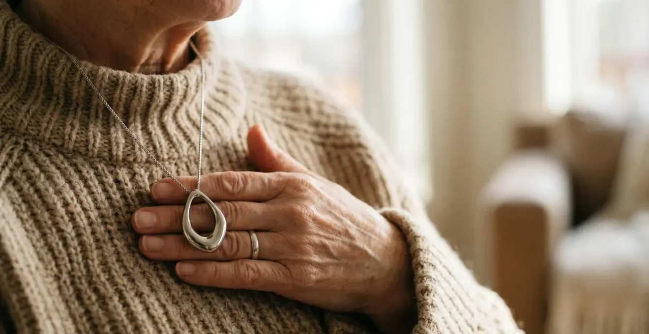 Elegant medical alert necklace pendant worn by senior, combining safety technology with refined jewelry design
